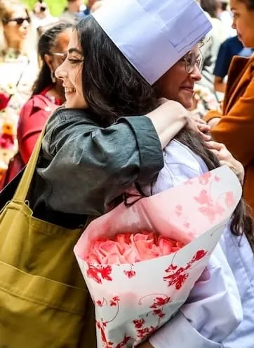 culinary grad hugs friend