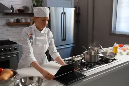 online culinary student taking cooking lesson on laptop