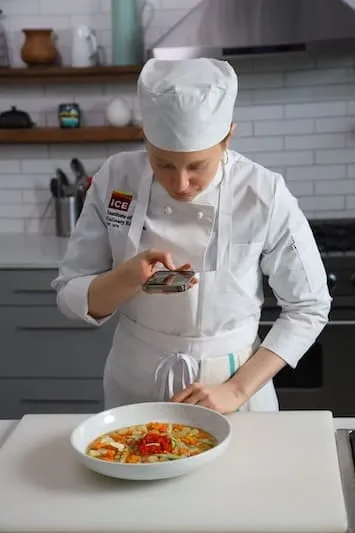 culinary school student takes photo of food