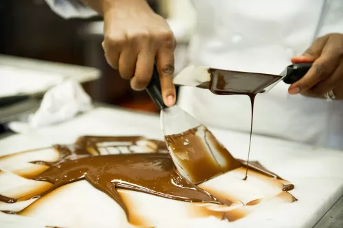 An ICE pastry program student learns to temper chocolate using the traditional method
