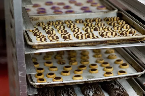A variety of classic cookies sit on sheet racks before setting out for display on Cookie Day