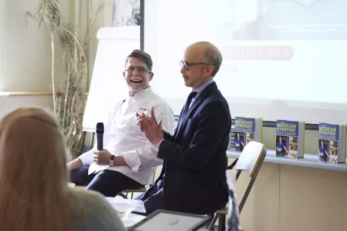 Chef Rick Bayless speaks to students and guests in a food business management class at ICE