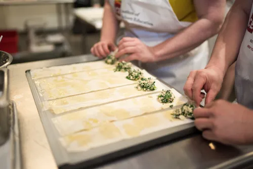 recreational students stuffing pasta dough