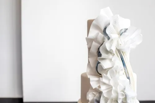 White fondant ribbon cake topper. 