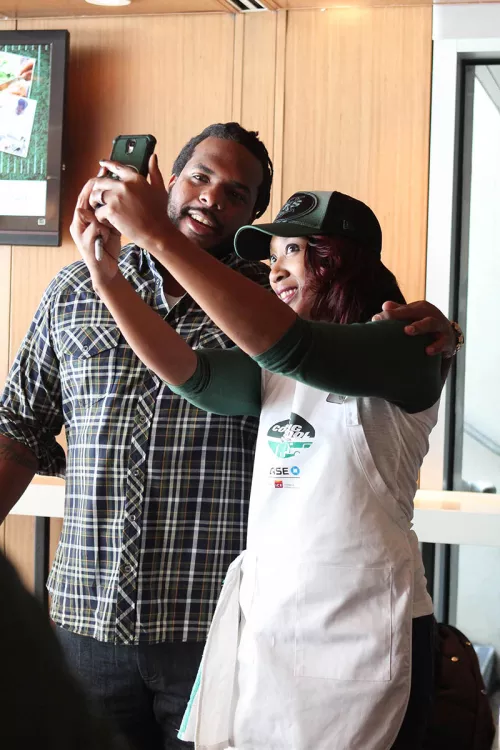 Fans taking a selfie at a Jets event.