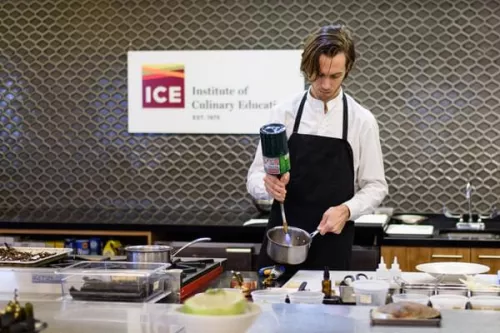 Chef Fredrik Berselius uses blowtorch at a demo at ICE, photo by Alex Shytsman
