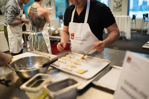 A guest glazes dumplings.