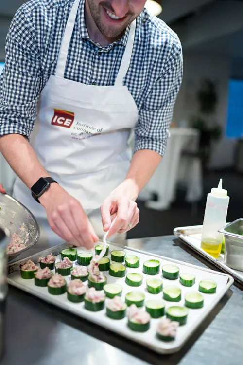 A guest tops cucumbers.
