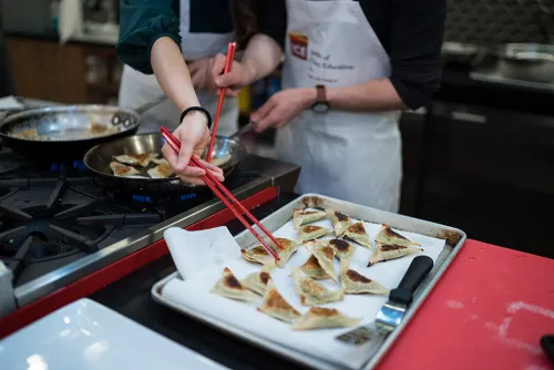 A guest glazes dumplings.