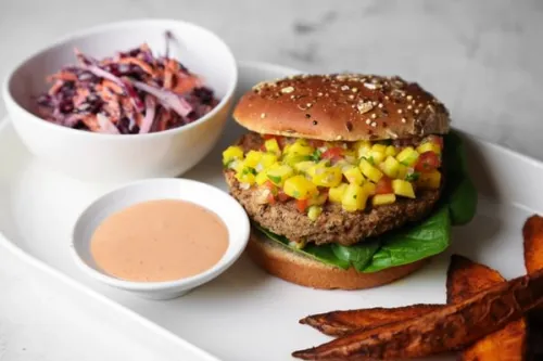 a burger with mango salsa and red cabbage from ICE's Culinary Nutrition curriculum