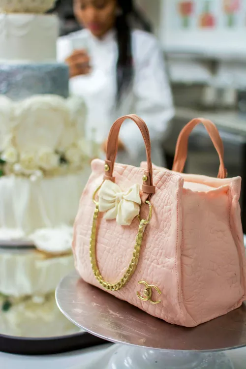 A pink cake modeled after a designer handbag in the ICE Professional Cake Decorating program