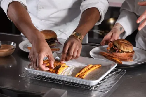 students from ICE's Culinary Nutrition course plate sweet potato fries alongside a burger