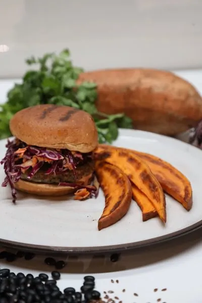 a veggie burger with red cabbage slaw and sweet potato fries from ICE's Culinary Nutrition curriculum