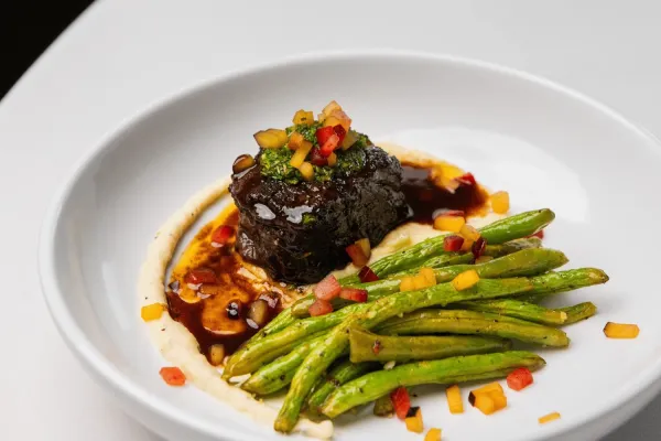 Plate with green beans, polenta, and steak.