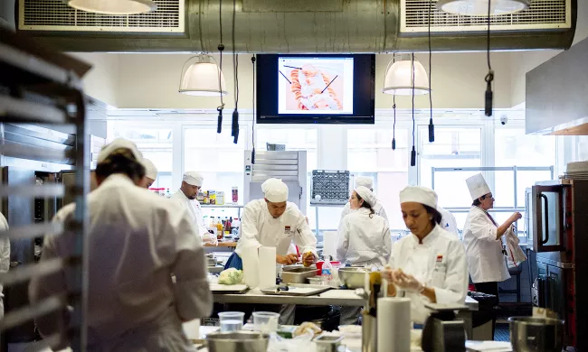 Students prepare dishes in culinary school at the Institute of Culinary Education