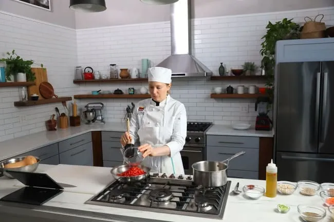student cooking in home kitchen