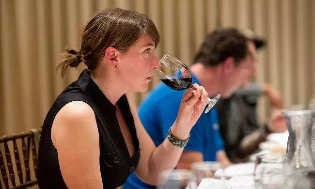 A student smells wine in the Wine Essentials class at the Institute of Culinary Education