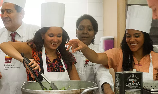Students at a hands-on cooking class.
