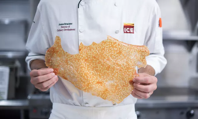 As part of a class providing culinary training in New York, vegetarian chicharron is displayed by a chef instructor at the Institute of Culinary Education
