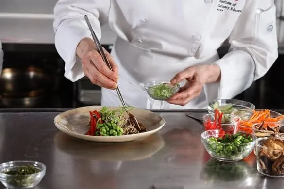 Student plating a health-supportive meal in their home kitchen