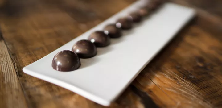 Michael Laiskonis’ Balsamic Caramel Bonbons are lined up on a dish.