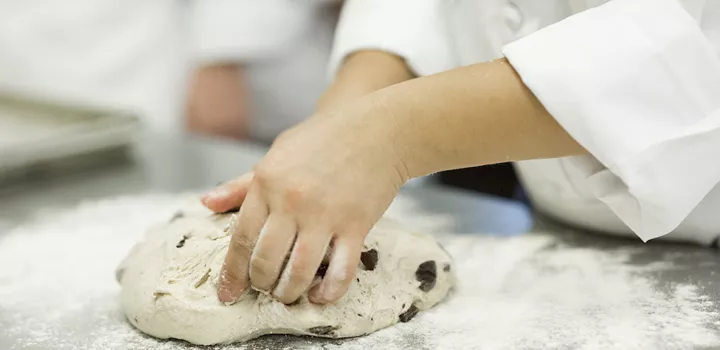 kneading dough in a bread baking class