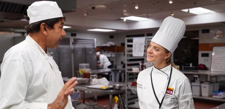 Chef Emilie Berner talks to an ICE student in class