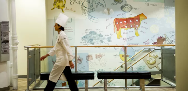 Chef walking through culinary school in New York
