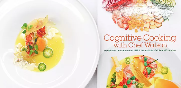 Cognitive Cooking with Chef Watson cookbook and a dish prepared from a recipe in the cookbook