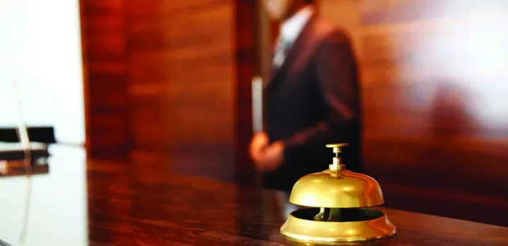bell on the front desk of a hotel