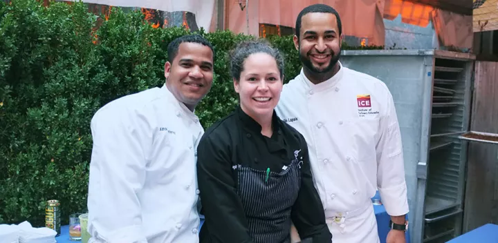 Chef Stephanie Izard smiles with two ICE students