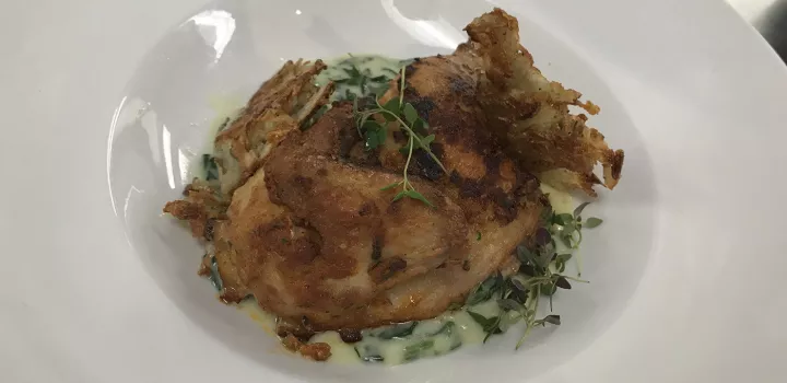 A chicken dish in a culinary arts class.