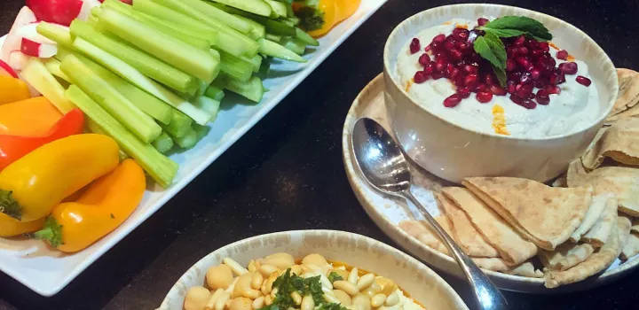 Hanan serves hummus and other spreads at the Healing Table events.