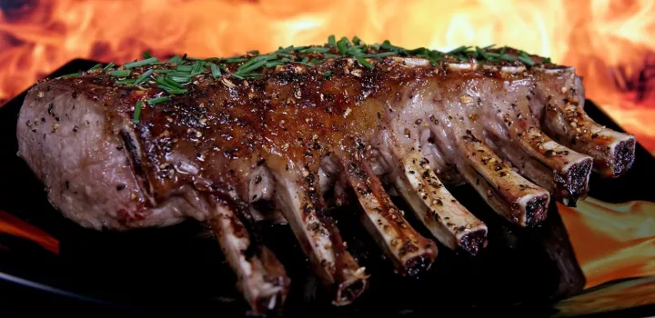 A rack of ribs sits on the barbecue
