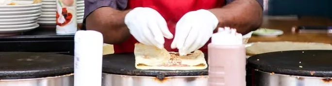 a person making crepes 