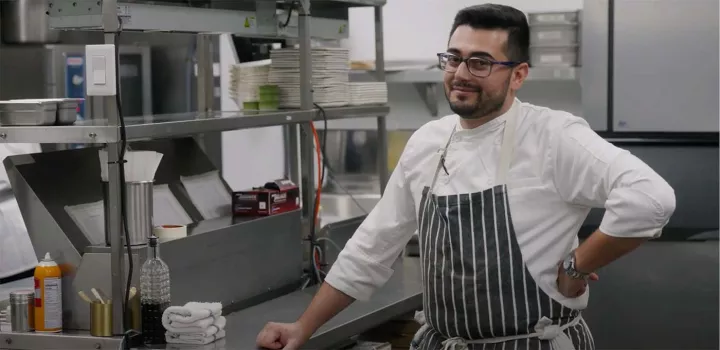 Chef Shant Halajian smiles inside of his kitchen