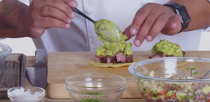 Chef Kelvin tops rib-eye with guacamole on his fresh tacos.