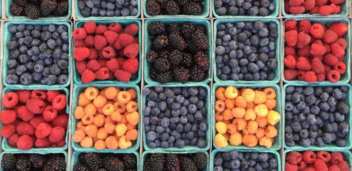 baskets of berries at a farmers' market