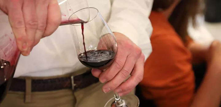 Pouring wine out of a decanter.