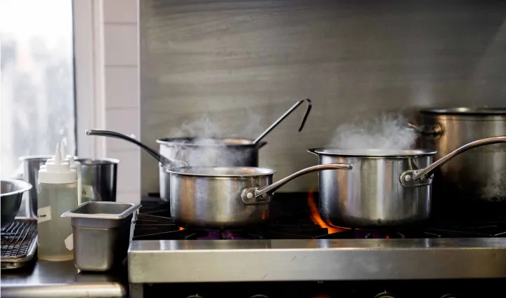Pots simmer on a professional stove at the Institute of Culinary Education