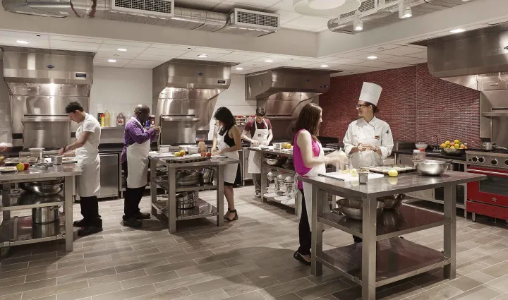 ICE Recreational students cooking in a kitchen with BlueStar ovens and ranges