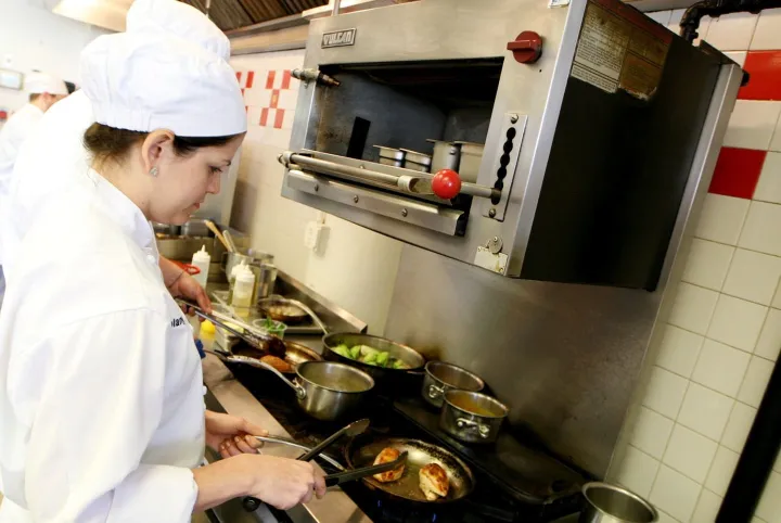 sous chef cooking at station