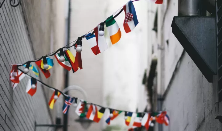 A banner of international flags - photo by Andrew Butler on Unsplash