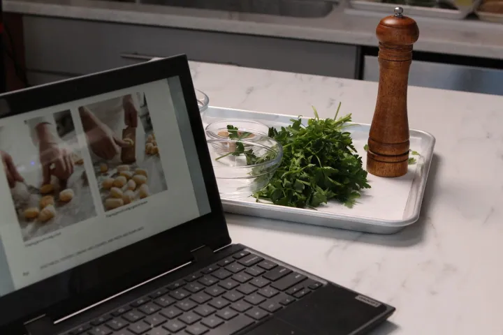 laptop on kitchen counter teaches culinary lesson