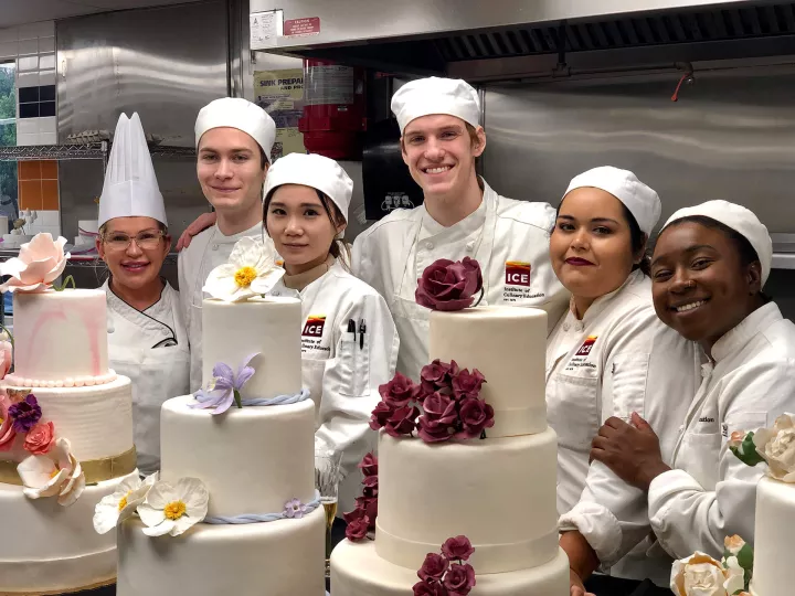 Pastry students and Chef Instructor smile together in one of ICE's Los Angeles pastry classes