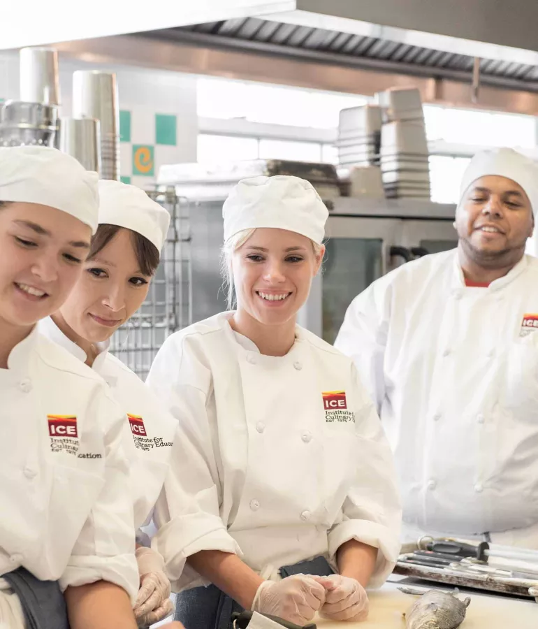 ICE New York students smiling in culinary school nyc at the Institute of Culinary Education, named "the best culinary school" by The Daily Meal